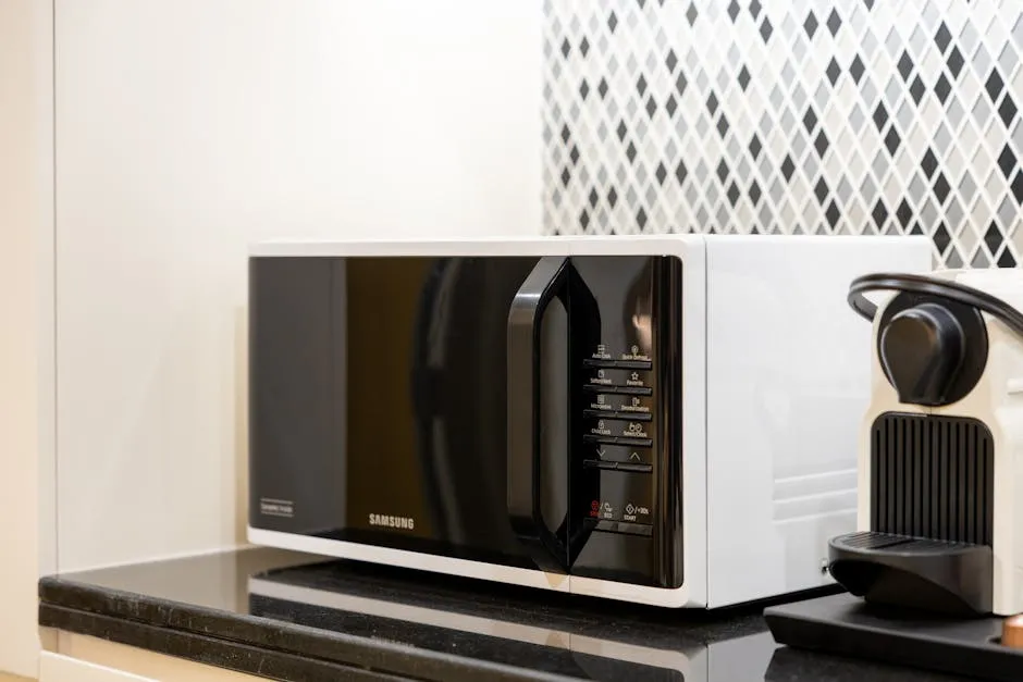 Samsung microwave and coffee maker on black counter in guest room at Travel Inn of Buford