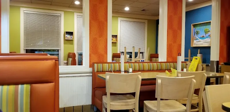 Colorful Captain D's restaurant interior with orange booths and tropical beach decor