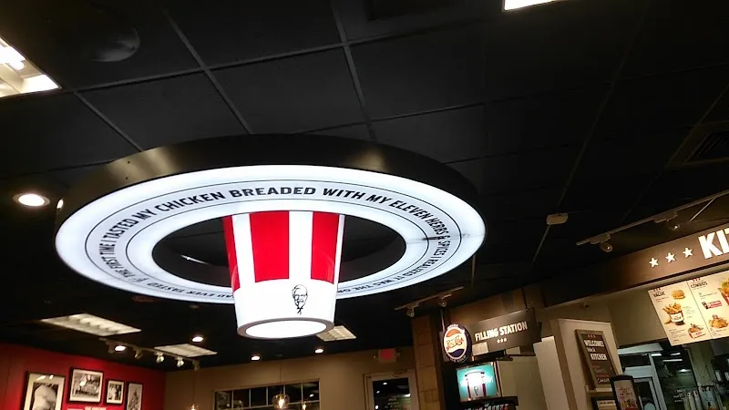 KFC bucket ceiling light fixture with text about eleven herbs and spices