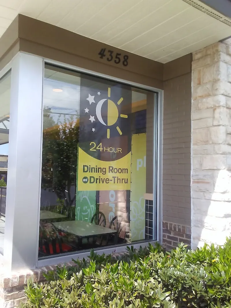 McDonald's window sign showing 24 hour dining room and drive-thru service